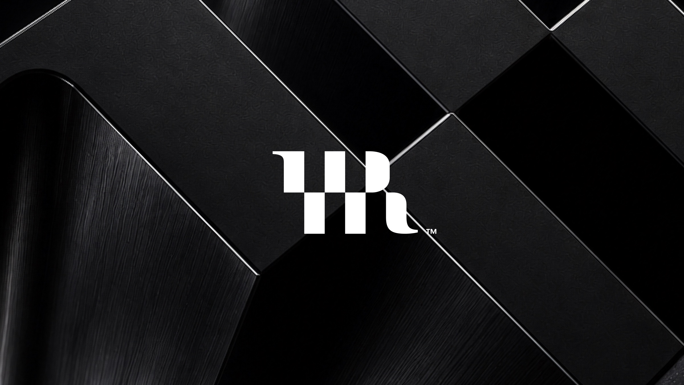 The white Reliever mark holding the center of a deep black dimensional ground of angular machined panels